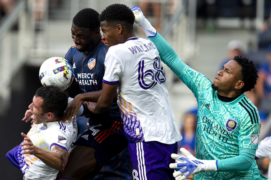 Ron Kuntz Sports Photographer of the Year - Third Place FC Cincinnati defender Tyler Blackett (24) attempts to put a header on goal as Orlando City defender Kyle Smith (24), Orlando City defender Thomas Williams (68) and Orlando City goalkeeper Pedro Gallese (1) defend in the first half of the MLS match at TQL Stadium in Cincinnati.  (Albert Cesare / The Cincinnati Enquirer)