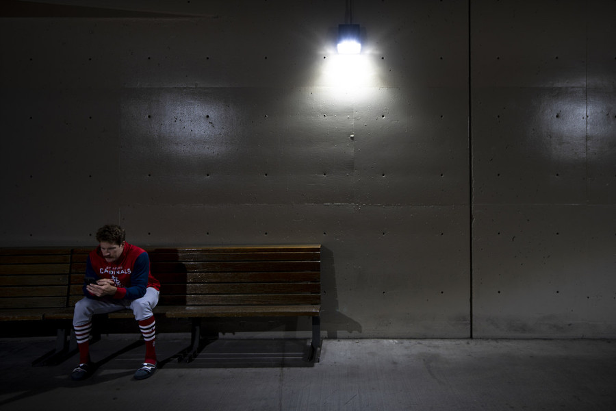 Ron Kuntz Sports Photographer of the Year - Third Place St. Louis Cardinals starting pitcher Miles Mikolas (39) sits in the field level concours during a rain delay before the scheduled game against the Cincinnati Reds at Great American Ball Park in Cincinnati.  (Albert Cesare / The Cincinnati Enquirer)