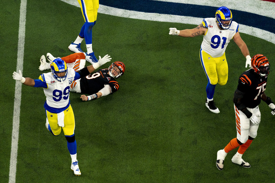 Ron Kuntz Sports Photographer of the Year - Third Place Los Angeles Rams defensive end Aaron Donald (99) celebrates after hitting Cincinnati Bengals quarterback Joe Burrow (9) as he threw on fourth down forcing a turnover on downs with the less than a minute to play in 4th quarter during Super Bowl 56, at SoFi Stadium in Inglewood, California.  (Albert Cesare / The Cincinnati Enquirer)