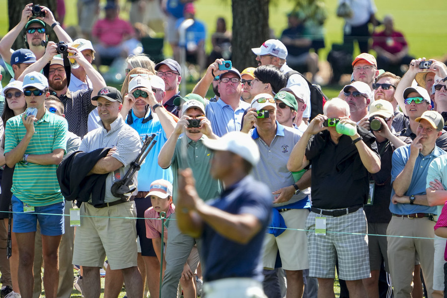 Sports Picture Story - Third Place, “The Masters”With cell phones banned from the course, patrons grab photos of Tiger Woods on the second hole fairway using point-and-shoot and disposable cameras during a practice round of The Masters golf tournament at Augusta National Golf Club.  (Adam Cairns / The Columbus Dispatch)