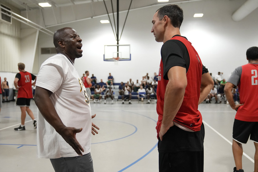 Sports Picture Story - Third Place, “Prison Basketball”Richland Correctional Institution warden Kenneth Black talks to former Ohio State basketball star Aaron Craft prior to a basketball game between Craft's group of "outsiders" and residents of the prison. As part of the Faithful In Serving Together ministry program, basketball, along with dialogue and religion, is used to help the incarcerated population find common ground.  (Adam Cairns / The Columbus Dispatch)