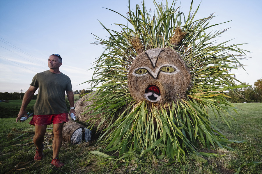 1st - Chuck Scott Student Photographer of the Year Co-owner Kevin C. Lewis, 51, of Albany, Ohio, pauses while spray painting a lion hay bale sculpture at Libby's Pumpkin Patch in Albany on Tuesday, September 19, 2023. "This is the second consecutive year I have done the lion. Next year, I might be putting up the African Queen", according to Lewis. He added that the seasonal attraction, which started in 2011, is named after his 19-year-old daughter. (Loriene Perera / Ohio University)