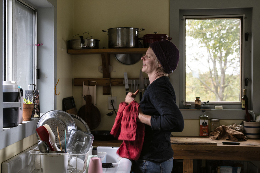1st - Chuck Scott Student Photographer of the Year Seed farmer Lindsay A. Klaunig, 39, of Toledo reacts while wiping her hands dry to prepare a lunch of raisin bagel with cream cheese in the kitchen of her home at Trouvaille Farm in the unincorporated community of Shade, Ohio, on Monday, October 16, 2023. "A lot of times when people come work for us, there's some that expect to be provided a huge farm lunch with this farmer's wife who's going to cook. Like what are you talking about? That's absolutely not true. We stuff food in our face, between you know, tasks," Klaunig shared.  (Loriene Perera / Ohio University)