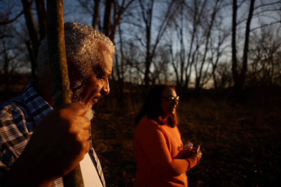 Feature Picture Story - 1st, “Tablertown Psalms ”David Butcher (left) takes a hike alongside his wife Rose Flowers in the woods during sunset. Butcher works with historians and genealogist to know the family history in Tablertown.  (Michael Blackshire / Ohio University)
