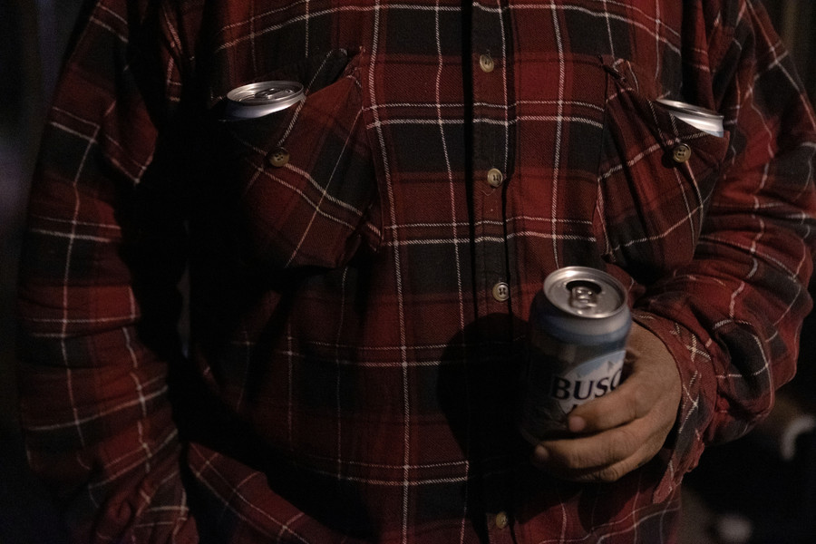 Feature Picture Story - 1st, “Tablertown Psalms ”Glenn Singer drinks a beer as two beers lay in his shirt pocket. “I would keep one in my pants pocket if it wasn’t likely to bust through my jeans,” Singer said jokingly. (Michael Blackshire / Ohio University)