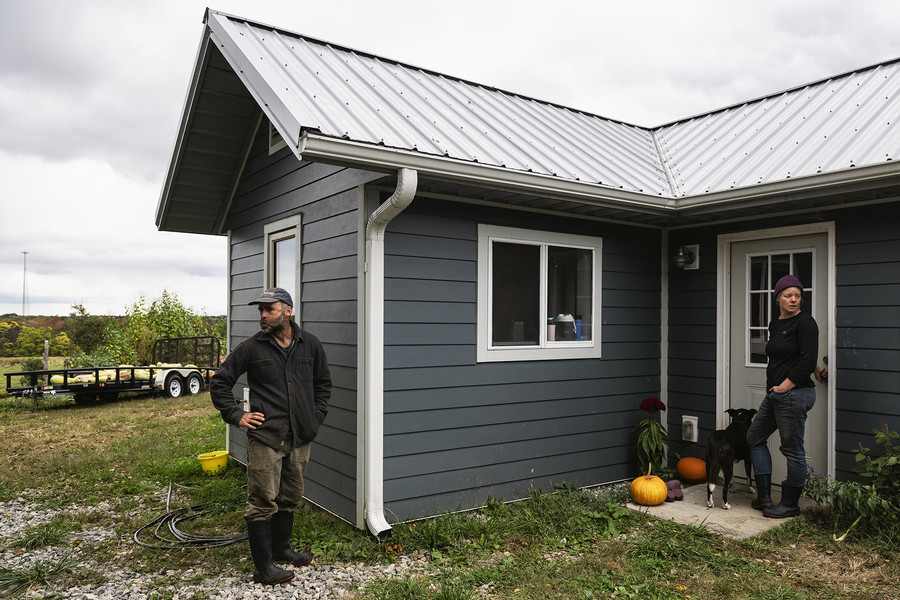 Feature Picture Story - 3rd, “Symphony of Soil”Seed farmer Lindsay A. Klaunig, 39, of Toledo, and her partner Michael S. Barnes, 48, of Santa Fe, N.M., look on outside their home before attempting to separate two bulls from a herd of cows at Trouvaille Farm in the unincorporated community of Shade, Ohio, on Monday, October 16, 2023. According to Barnes, the cattle are part of his livestock business, which he operates as a separate limited liability company from Klaunig's seed farming business, but they have an agreement to help each other where necessary.  (Loriene Perera / Ohio University)