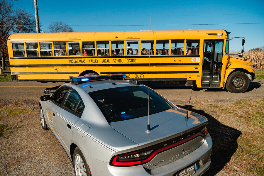 News Picture Story - 1st, “Tuscarawas Valley Bus Tragedy”A trooper from the Ohio State Highway Patrol watches over traffic during dismissal time, Tuesday, Nov. 14 at Tusky Valley Schools, Zoarville, Ohio. (Andrew Dolph / The Times Reporter)