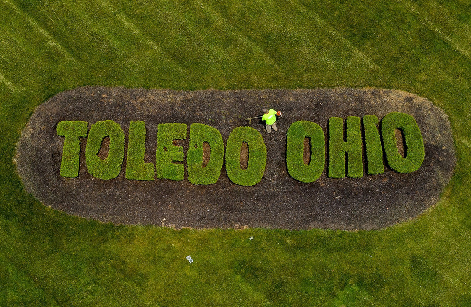 Pictorial - Award of Excellence, “Toledo Hedges”An aerial view from a drone shows David Perez, with AMD Finishes, as he spruces up the grounds around the hedges spelling out the city's name at the corner of Cherry and Summit streets in Toledo on Monday, May 22, 2023.  (Kurt Steiss / The Blade)