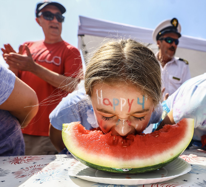 1st - Photographer of the Year - Large Market Clara Mayers, 10, of Toledo wishes everyone a happy holiday while competing in the annual watermelon eating contest as part of the Harvard Circle Fourth of July Celebration Tuesday, July 4, 2023, in Toledo.  (Jeremy Wadsworth / The Blade)
