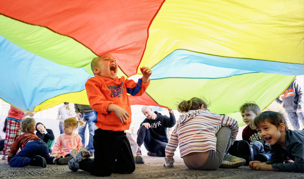 1st - Photographer of the Year - Large Market Koda Himes, 2, of Sylvania plays under a parachute during a dance party for kids ages 2-5 Monday, February 13, 2023, at the King Road Library in Sylvania.   (Jeremy Wadsworth / The Blade)
