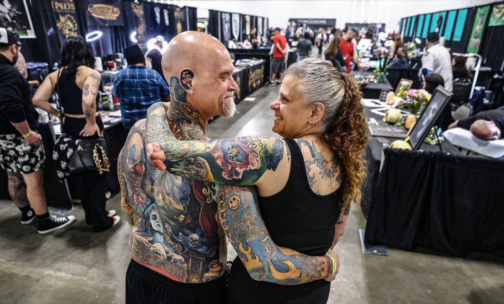 1st - Photographer of the Year - Large Market Chris McCrea and his wife Michelle McCrea of Adrian, Michigan, explore the Toledo Tattoo Festival Saturday, April 22, 2023, at the Glass City Convention Center in Toledo.  (Jeremy Wadsworth / The Blade)