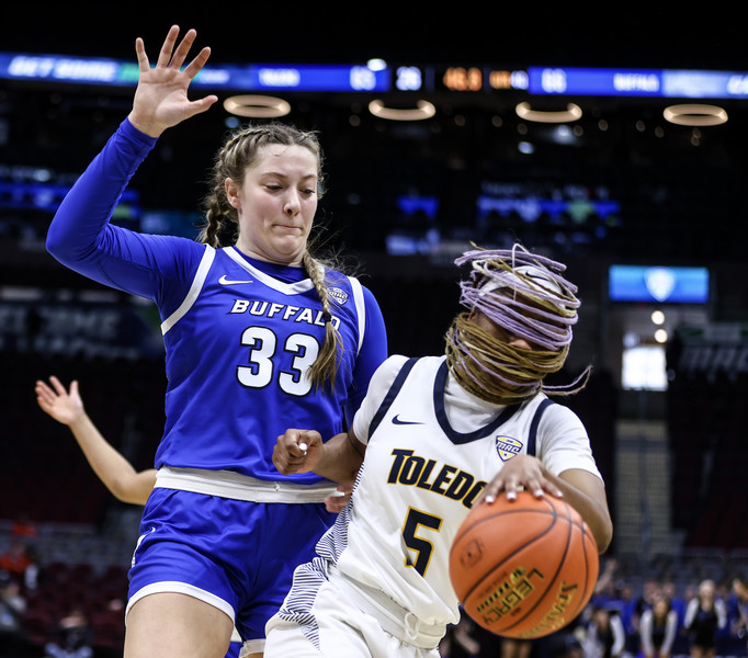 1st - Photographer of the Year - Large Market University of Toledo guard Quinesha Lockett drives past Buffalo guard Hattie Ogden during the quarterfinals of the Women’s MAC Basketball Tournament Wednesday, March 8, 2023, at the Rocket Mortgage FieldHouse in Cleveland. UT defeated Buffalo, 75-74, in overtime.  (Jeremy Wadsworth / The Blade)