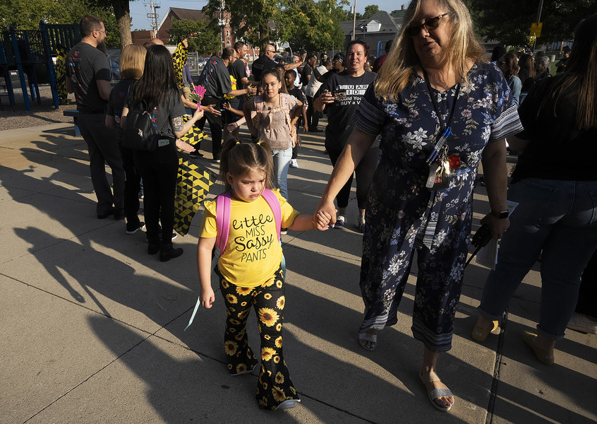 2nd - Photographer of the Year - Large Market Sara Rannebarger, 6, wears her “Miss Sassy Pants” shirt and cries as she is walked into school by Avondale Principal April Knight during a “Clap In” that features mascots from the Columbus Crew and the Columbus Blue Jackets at Avondale Elementary School.  (Brooke LaValley / The Columbus Dispatch)