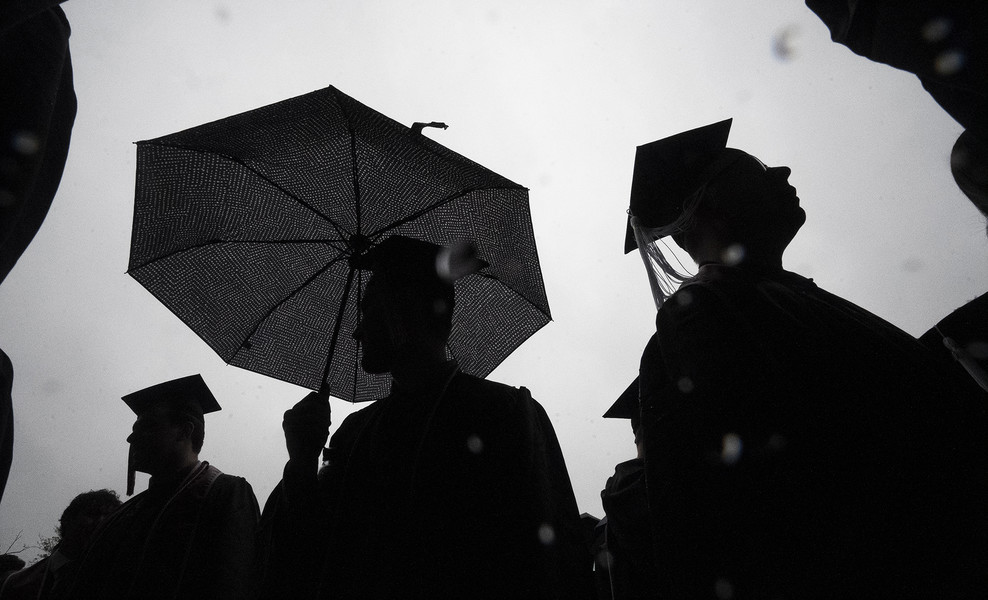 2nd - Photographer of the Year - Large Market Drew Dilcher, graduating with a Bachelors Degree in Accounting, holds an umbrella while walking to the French Field House in the rain before Spring Commencement ceremonies at Ohio Stadium in Columbus, Ohio on May 7, 2023.  (Brooke LaValley / The Columbus Dispatch)