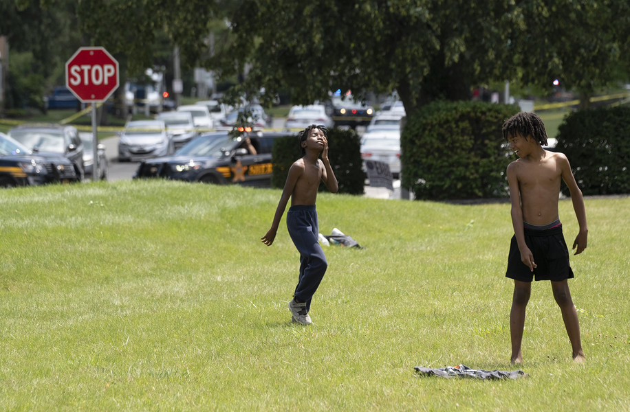 2nd - Photographer of the Year - Large Market Jay Fisher, 10, rubs his eyes while playing football in a field near a crime scene that was being investigated on Nationwide Boulevard on the West Side of Columbus (Brooke LaValley / The Columbus Dispatch)