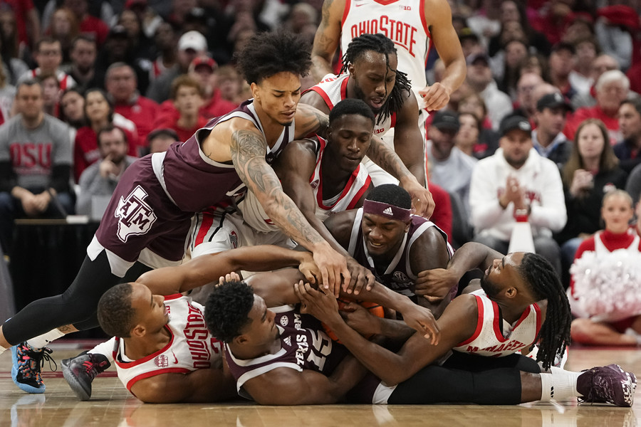3rd - Photographer of the Year - Large Market Ohio State and Texas A&M  players dive on a loose ball during the first half of the NCAA basketball game at Value City Arena. (Adam Cairns / The Columbus Dispatch)
