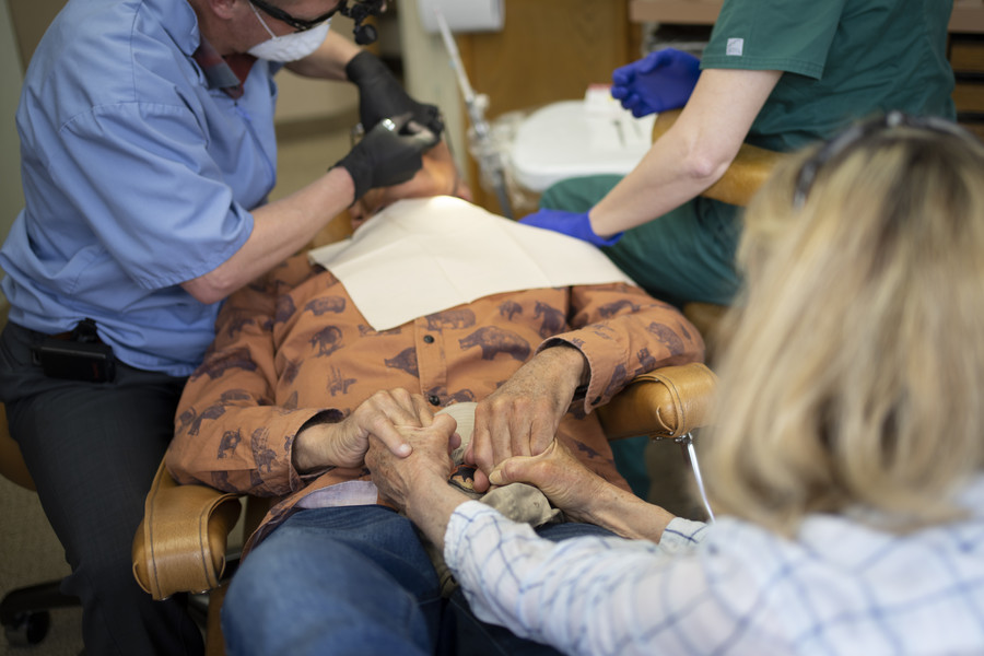 3rd - Photographer of the Year - Large Market After telling him that the dentist appointment was her own just to get him to the office, Suzi Hanna holds the hands of her husband, Jack, as Dr. Michael Bowman repairs a crown and cavity in Jack’s mouth. (Adam Cairns / The Columbus Dispatch)