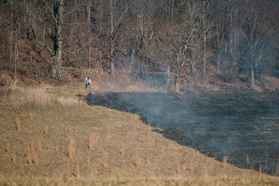 1st - Photographer of the Year - Small Market A man is seen attempting to extinguish a brush fire in the area of the 3000 block of Ramp Rd NE, Tuesday, Mar. 7 in Fairfield Township. According to firefighters on scene a fire was started in a barrel and spread to the land. A no-burn ordinance was in effect county-wide from 6am to 6pm. (Andrew Dolph / The Times Reporter)