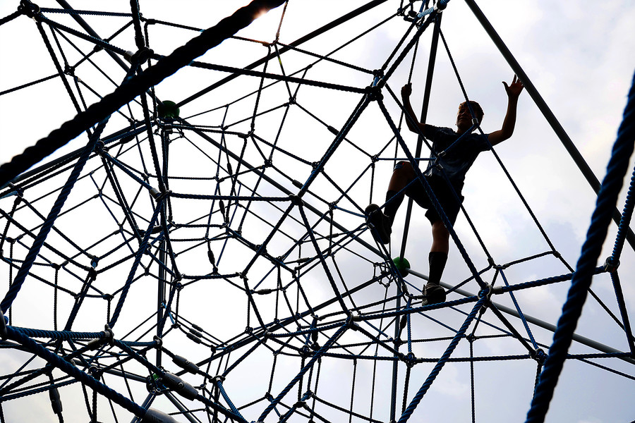 Award of Excellence - Photographer of the Year - Small Market Jordan Elias, 11, looks like Spider-Man as he climbs a web made of ropes on a playground feature at Melvin Miller Park Tuesday, July 18, 2023.  (Bill Lackey / Springfield News-Sun)