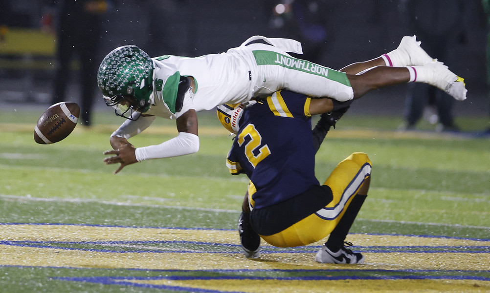 Award of Excellence - Photographer of the Year - Small Market Springfield's Ty Myers forces Northmont's Cahke Cortner to fumble the ball as he tackles him during Friday's game.  (Bill Lackey / Springfield News-Sun)