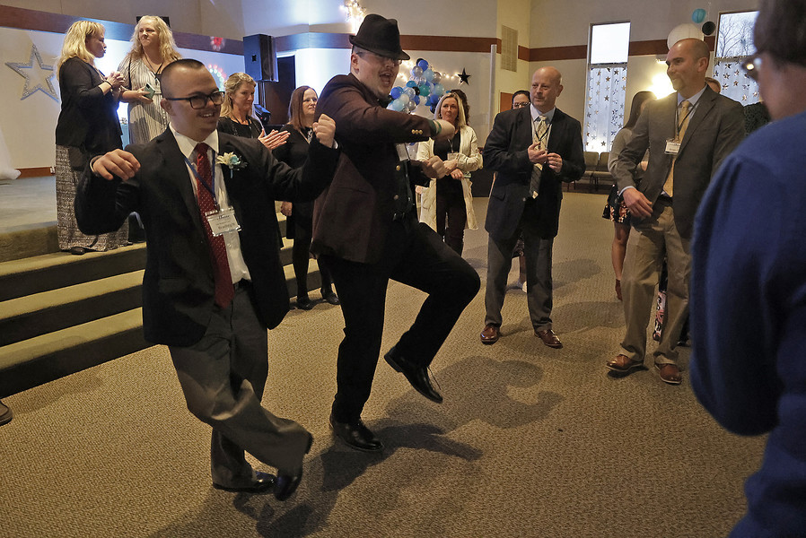 Award of Excellence - Photographer of the Year - Small Market Roy Jenkins and Peter Miller show off their dancing skills during the Night to Shine event at the Lawrenceville Church of God on Friday, Feb. 10, 2023. (Bill Lackey / Springfield News-Sun)