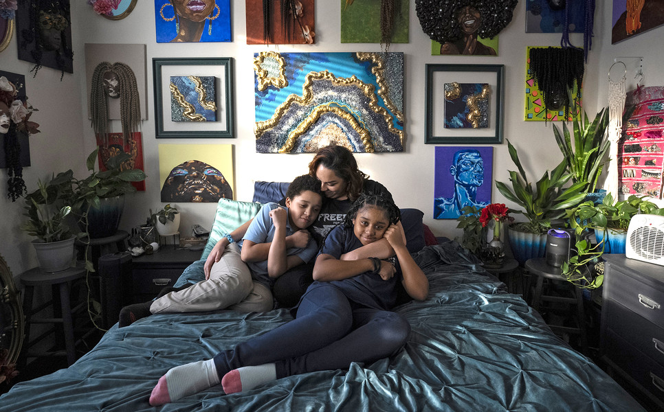 Portrait Personality - Award of Excellence, “Emergency Benefits End”Jasmine Wooten sits with her two children Arius Wooten, 8, left, and Naomi Wooten, 11, on her bed in their home on the East Side of Columbus. Jasmine is an artist, her work hangs on the wall behind her. Emergency SNAP benefits helped to feed her family during the Covid-19 Epidemic. She is a single mom who recently earned her Masters Degree in Social Work from The Ohio State University.  (Brooke LaValley / The Columbus Dispatch)