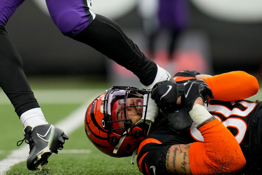Sports Action - 1st, “Dragged”Cincinnati Bengals safety Jessie Bates III (30) hangs onto the foot of Baltimore Ravens tight end Isaiah Likely (80) after a catch in the fourth quarter at Paycor Stadium in Cincinnati on Sunday, Jan. 8, 2023. The Bengals clinched a home playoff game with a 27-16 win over the Ravens. (Sam Greene / The Cincinnati Enquirer)