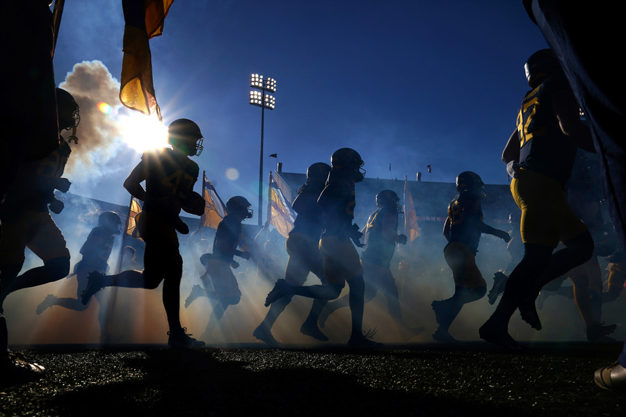 Sports Feature - Award of Excellence, “Taking the Field”The West Virginia Mountaineers takes the field prior to an NCAA college football game against the Cincinnati Bearcats, Saturday, Nov. 18, 2023, at Milan Puskar Stadium in Morgantown, W. Va.  (Kareem Elgazzar / The Cincinnati Enquirer)