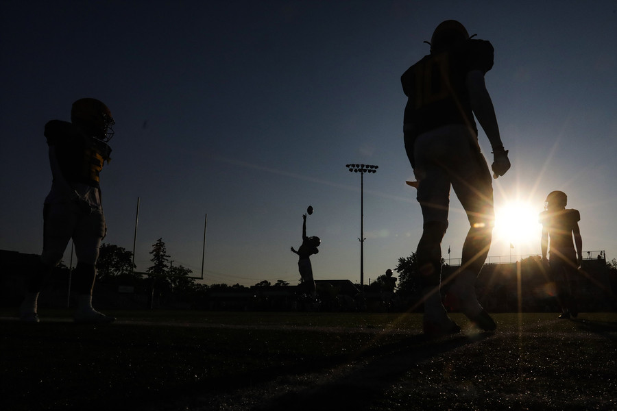 Award of Excellence - Ron Kuntz Sports Photographer of the Year Whitmer warms up before the start of an NLL Buckeye Division high school football game against Anthony Wayne at Whitmer High School in Toledo on Friday, September 22, 2023.  (Rebecca Benson / The Blade)