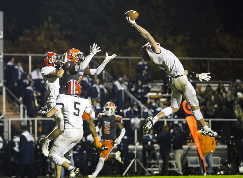 Award of Excellence - Ron Kuntz Sports Photographer of the Year Napoleon’s Trey Rubinstein catches an interception with one hand intended for Southview’s Emite Lamb during a NLL Cardinal Division football game at Southview High School in Sylvania on Friday, October 20, 2023. Southview defeated Napoleon, 20-14.  (Rebecca Benson / The Blade)