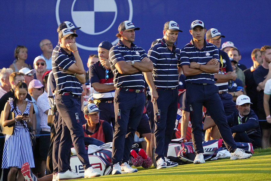 Sports Picture Story - 1st, “Ryder Cup”Team USA waits for the final pairing on the 18th hole during day one fourballs round for the 44th Ryder Cup golf competition at Marco Simone Golf and Country Club.  (Adam Cairns / The Columbus Dispatch)