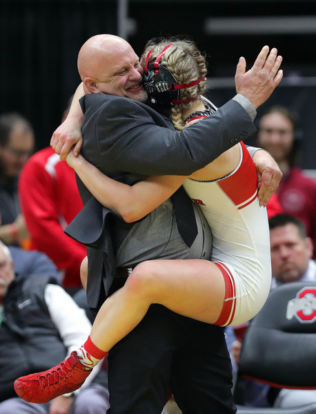 Sports Picture Story - 2nd, “Girls State Wrestling”Jaydyn McKinney (right) leaps into the arms of her father Bill McKinney after winning the 135 girls championship in the OHSAA  state wrestling tournament  at the Jerome Schottenstein Center, Sunday, March 12, 2023, in Columbus, Ohio. (Jeff Lange / Akron Beacon Journal)