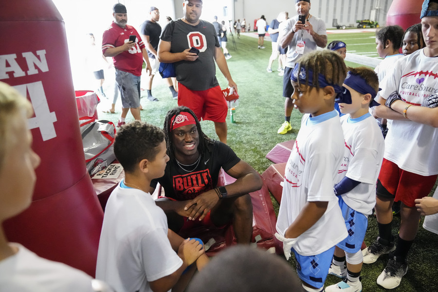 Sports Picture Story - 3rd, “Marvin Harrison Jr. ”Ohio State wide receiver Marvin Harrison Jr. takes photos and signs autographs for kids at a football camp following his summer workout at the Woody Hayes Athletic Center. (Adam Cairns / The Columbus Dispatch)