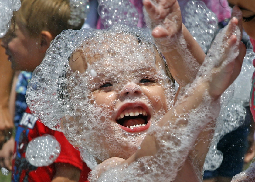 First Place, Photographer of the Year - Small Market - Bill Lackey / Springfield News-SunAdam Hawksworth enjoys the bubbles raining down during the National Trail Parks and Recreation District's Foam Frenzy parties Thursday, July 18, 2024 at Northeastern School in South Vienna. 