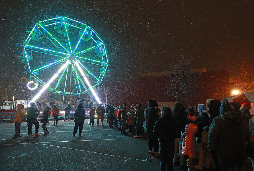 First Place, Photographer of the Year - Small Market - Bill Lackey / Springfield News-SunA line of people wait in the bitter wind and snow to ride the farris wheel at the Holiday in the City Grand Illumination Friday, Nov. 29, 2024. 