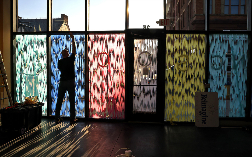 First Place, Photographer of the Year - Small Market - Bill Lackey / Springfield News-SunPaul Johnston is caught by the sunlight as he straightens the streamers covering the windows of the new business he and his wife, Kari, are opening along South Fountain Avenue in downtown Springfield. The new retail business, called Reimagine Gifts & More, is looking at a grand opening date of October 15. 