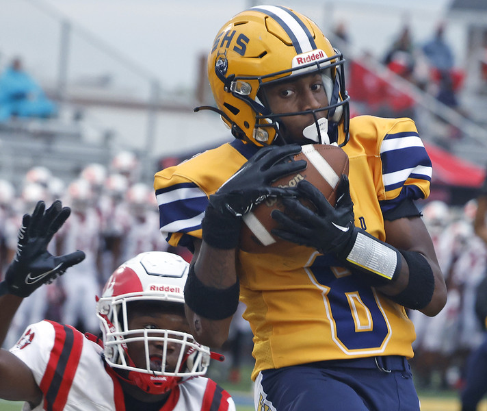 First Place, Photographer of the Year - Small Market - Bill Lackey / Springfield News-SunSpringfield's Sherrod Lay catches a touchdown pass under pressure from Trotwood's Nate Lockwood.