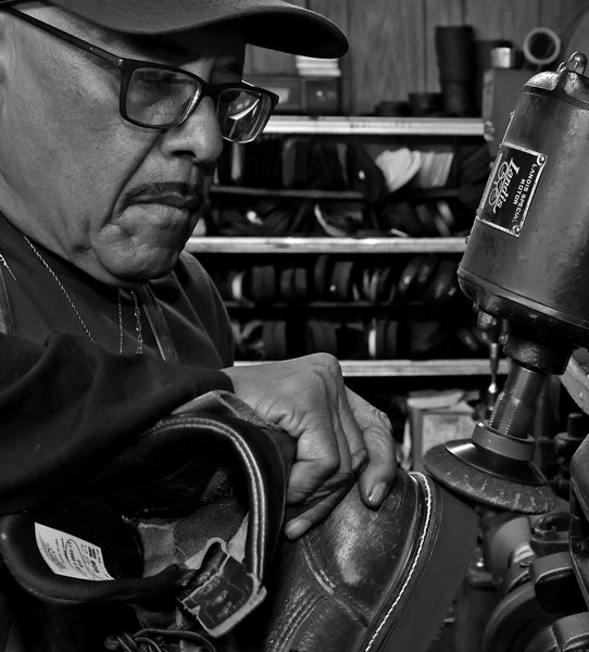 First Place, Photographer of the Year - Small Market - Bill Lackey / Springfield News-SunClifford Borden smooths out a sole he replaced on a pair of work boots at Pritchet Shoe Service, 