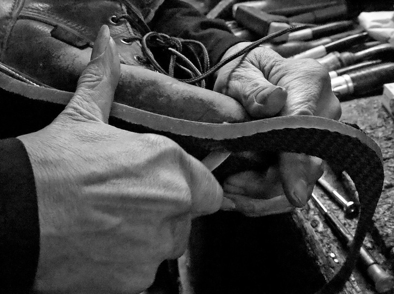 First Place, Photographer of the Year - Small Market - Bill Lackey / Springfield News-SunClifford Borden trims the sole of a boot after replacing it. 