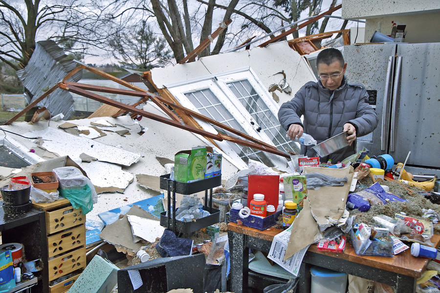 First Place, Photographer of the Year - Small Market - Bill Lackey / Springfield News-SunShoji Uota pours his dog some fresh water after finding the dog's bowl in the remains of his kitchen Wednesday, Feb. 28, 2024. Uota's house was destroyed a few hours earlier in an F2 tornado. 