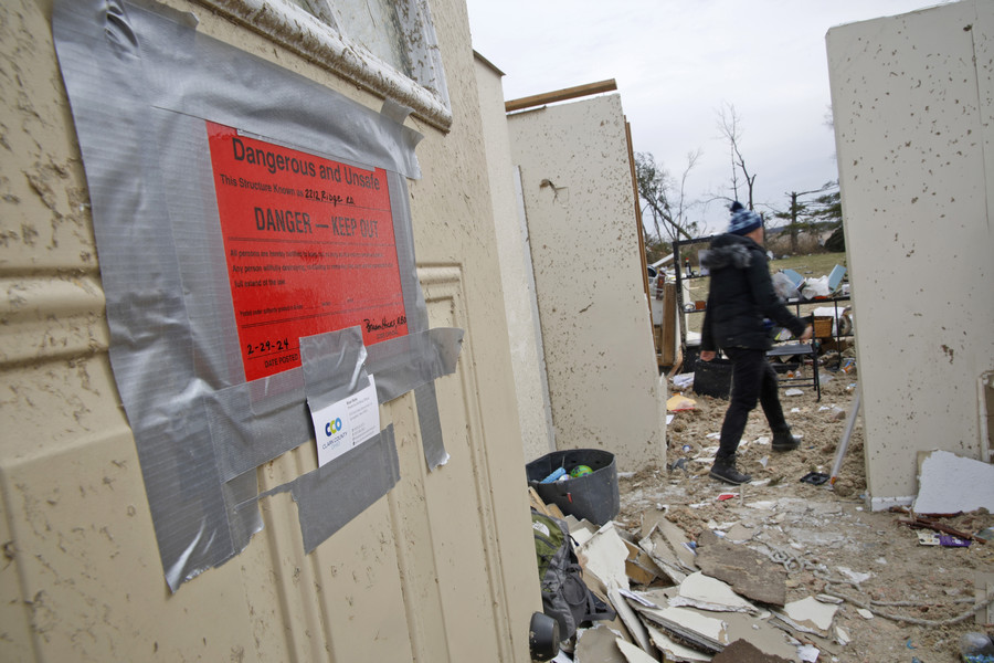 First Place, Photographer of the Year - Small Market - Bill Lackey / Springfield News-SunEmi Campbell and her family collect the belongings Friday, March 1, 2024 as they prepare to move out of their Ridge Road house that was destroyed in Wednesday's tornado. 