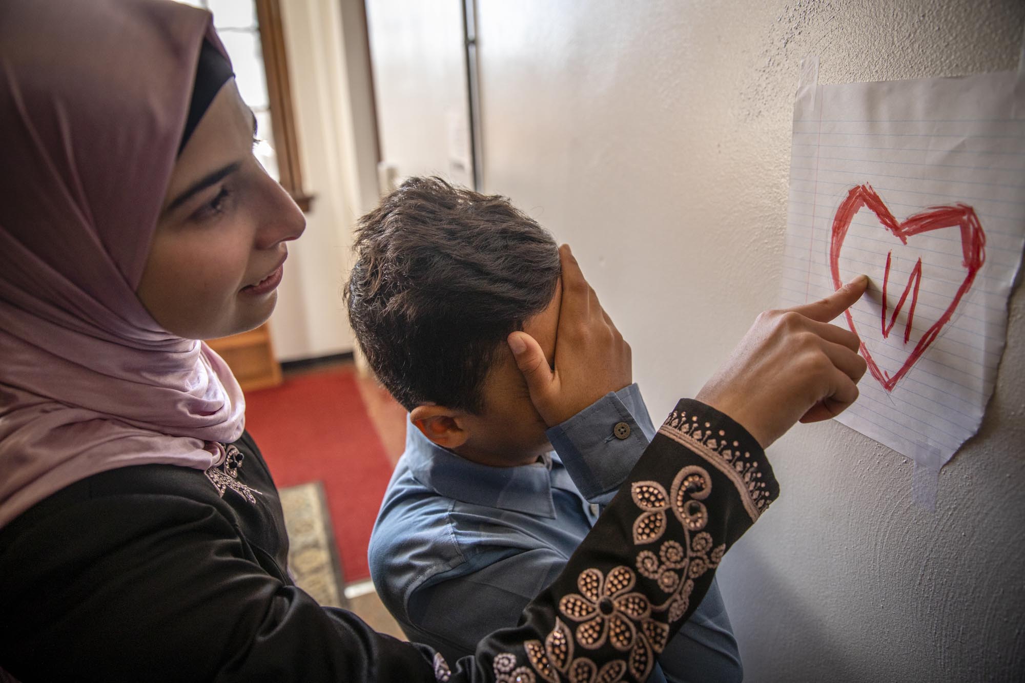 Abood reacts in embarrassment after Hanadi points out that a note he drew and proudly displayed contained a backwards “N”.
