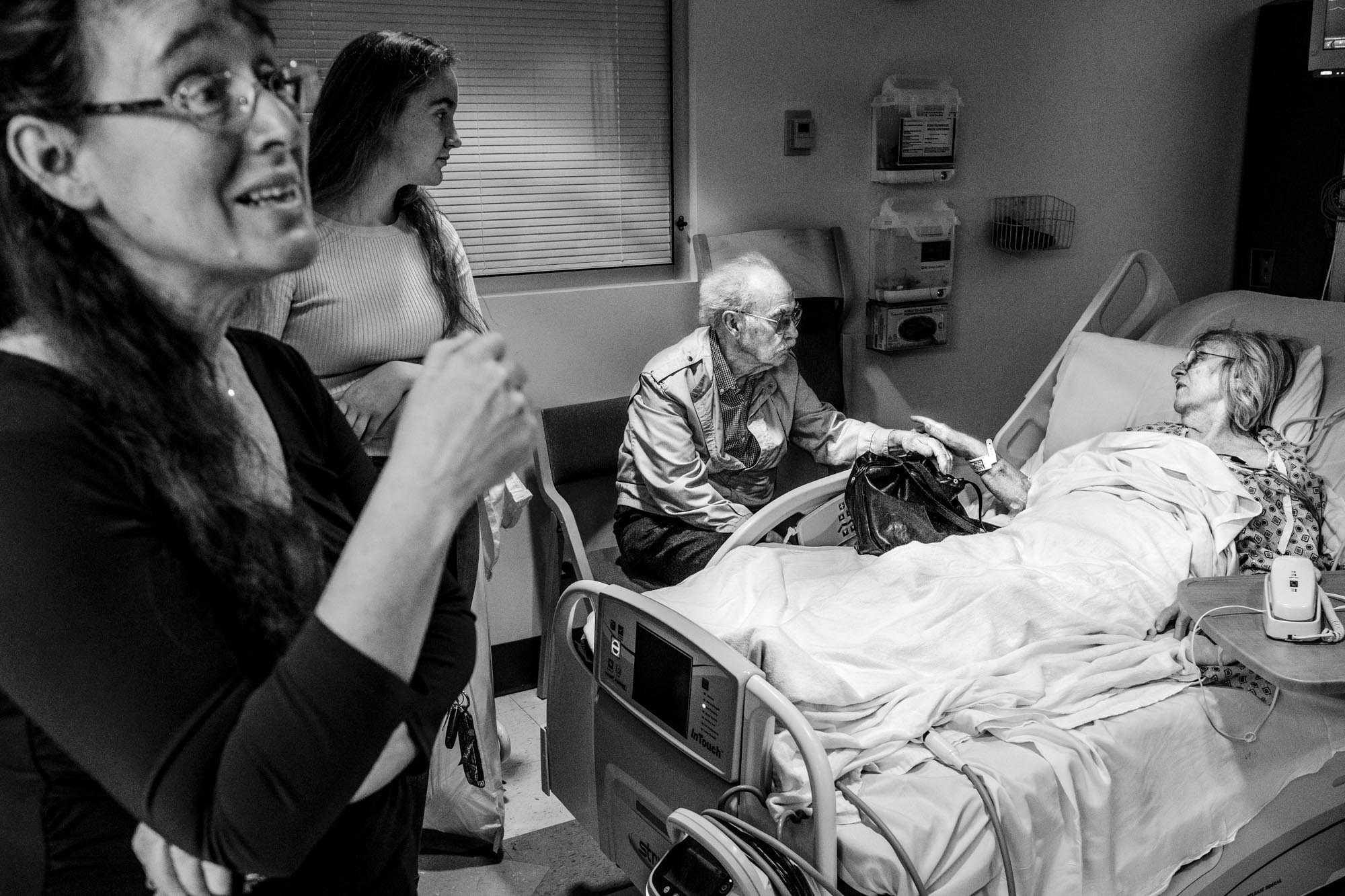 After suffering a heart attack, Eva Rettig tells her husband Matthias to “go home and rest”, May 4, 2018, as her daughter Barbara (far left) and granddaughter Julianna visit her.