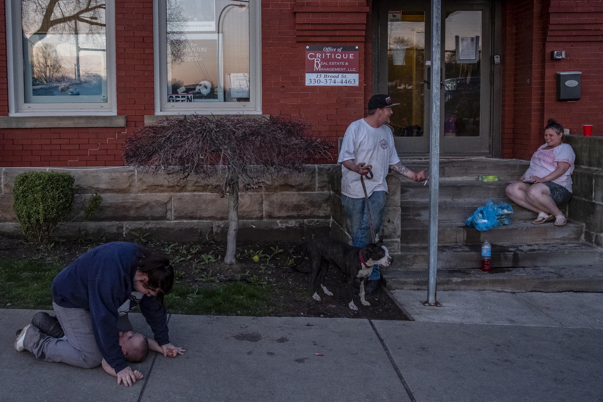 People, all homeless, spend their evening outside the front entrance to 15 Broad St., home to Tent City. Multiple complaints have been made by nearby residents about people loitering on the sidewalk.