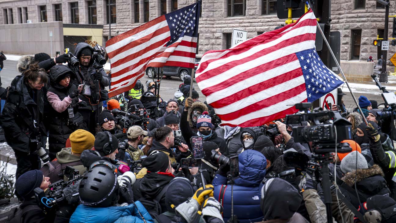 December - 2nd place spot news - Tyler Darling waves a Black Lives Matter flag among motorcycle tire smoke on High Street during a protest that started at the Franklin County Sheriff's Office building in Columbus. 500 protesters were demanding justice for Casey Goodson Jr. after Deputy Jason Meade fatally shot Goodson at his home in the Northland neighborhood on the city's northeast side. Kyle Robertson / The Columbus Dispatch