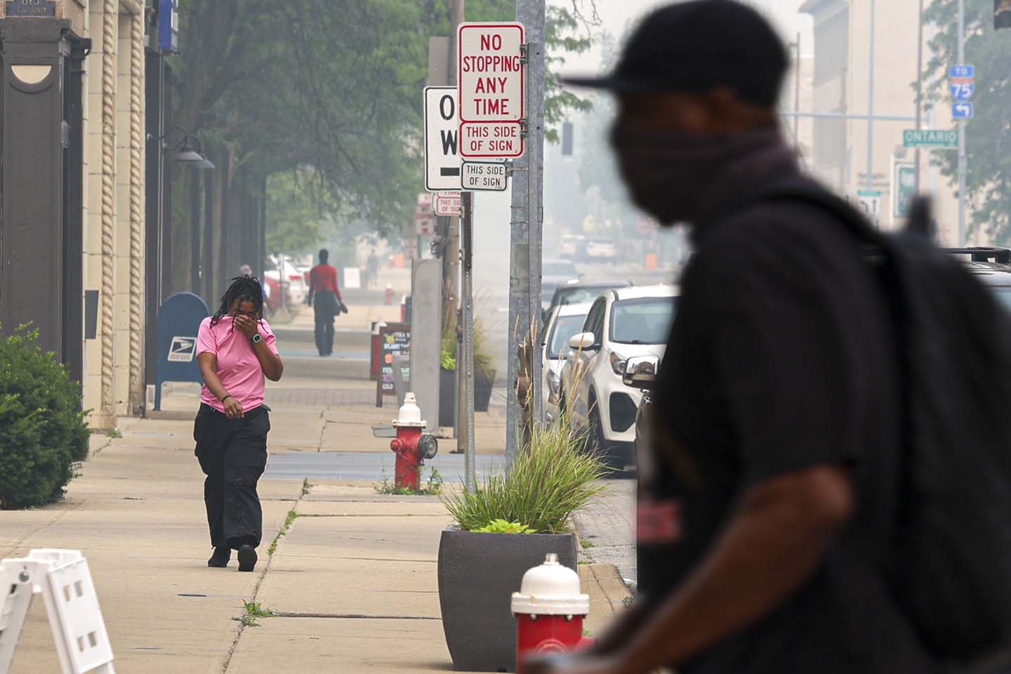 Wildfire Smoke December - 2nd place spot news - Tyler Darling waves a Black Lives Matter flag among motorcycle tire smoke on High Street during a protest that started at the Franklin County Sheriff's Office building in Columbus. 500 protesters were demanding justice for Casey Goodson Jr. after Deputy Jason Meade fatally shot Goodson at his home in the Northland neighborhood on the city's northeast side. Kyle Robertson / The Columbus Dispatch